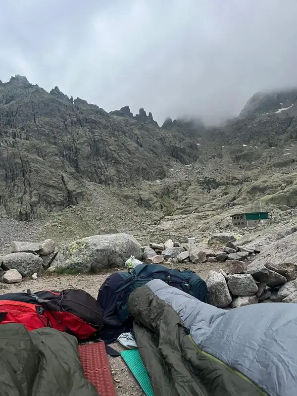 Sleeping bags laid out in a rocky mountain valley